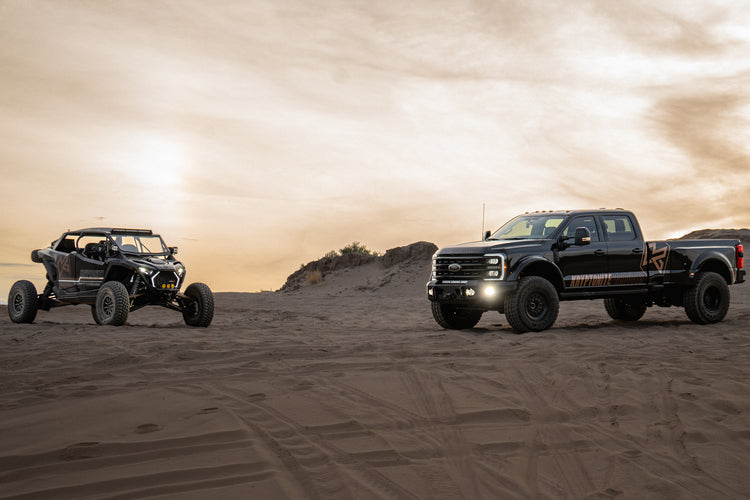 Ford Super Duty and a Polaris RZR Pro R in the desert